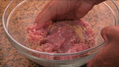Amasando la carne molida con huevos y pan rallado en un bol
